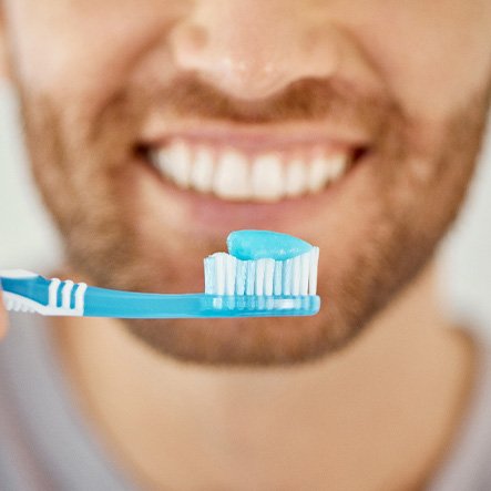 a close-up of a patient holding their toothbrush