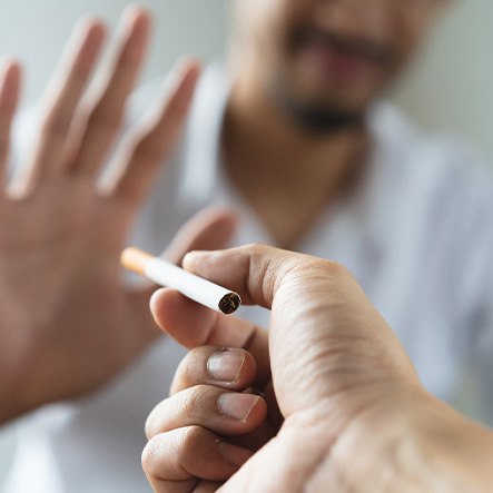 a person being offered a cigarette