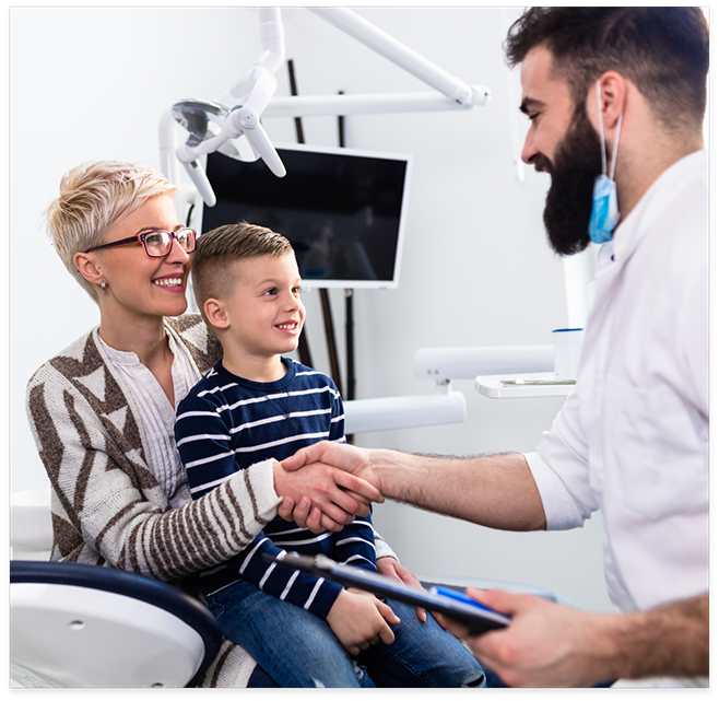 Woman with child in lab shaking hands with dentist