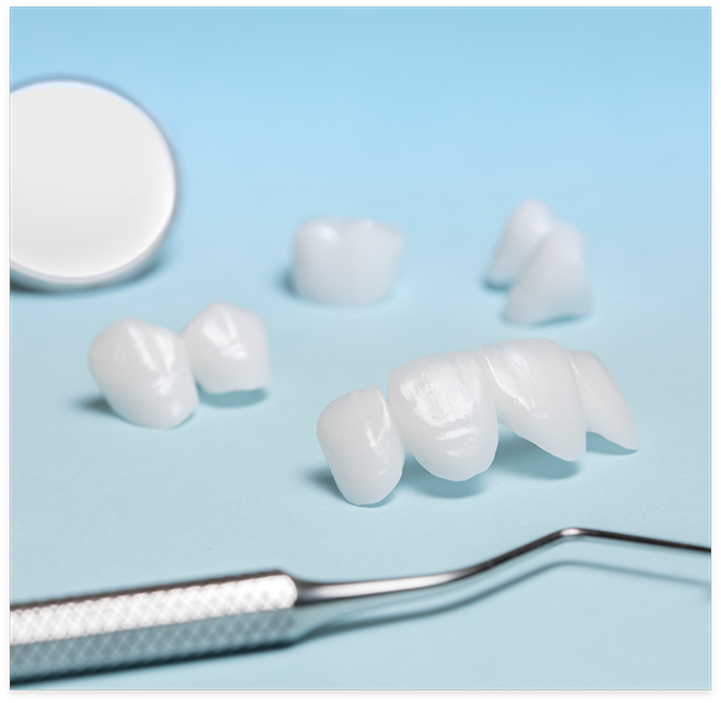 Natural looking crowns and bridges next to dental instruments