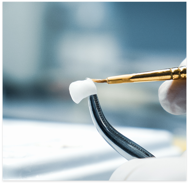 Dental crown being polished with a brush