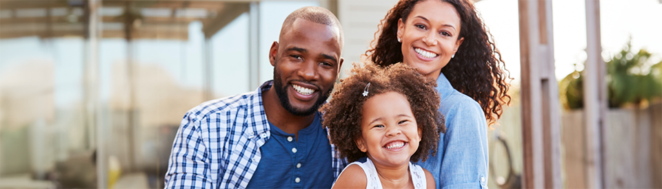 Parents with little girl smiling