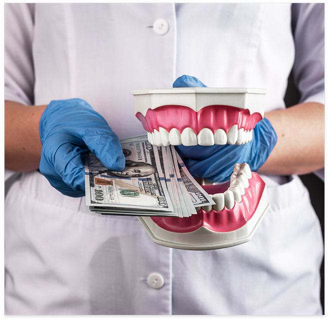 Dentist holding dentures and wad of cash