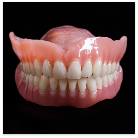 Close up of full dentures on black background