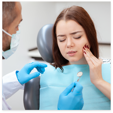 Woman with tooth pain visiting emergency dentist