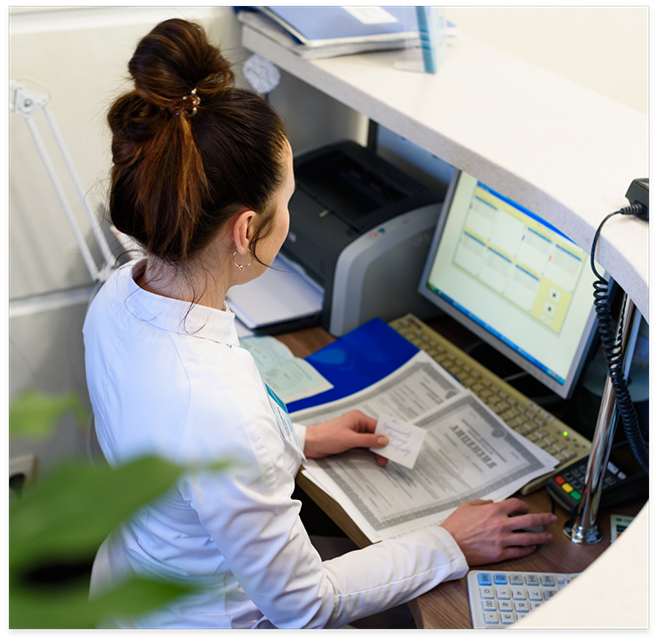 Dental team member working on computer at desk