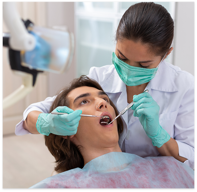 Female dentist examining a patients teeth