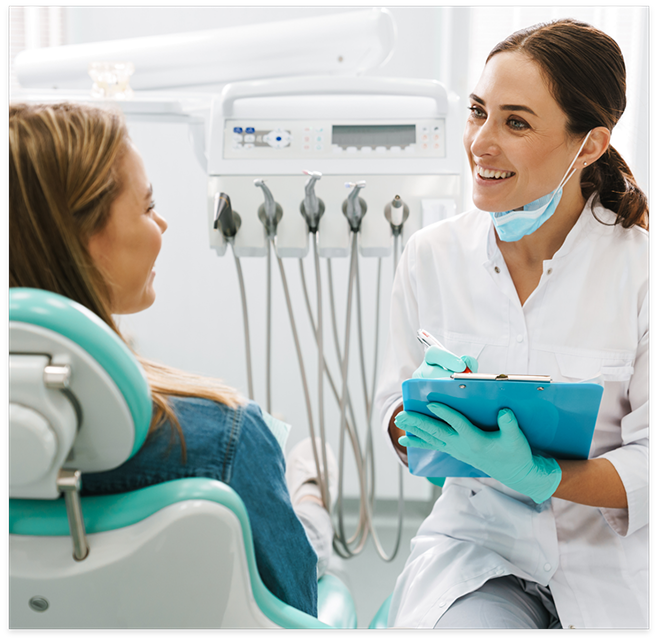 Dentist talking to patient sitting in dental chair