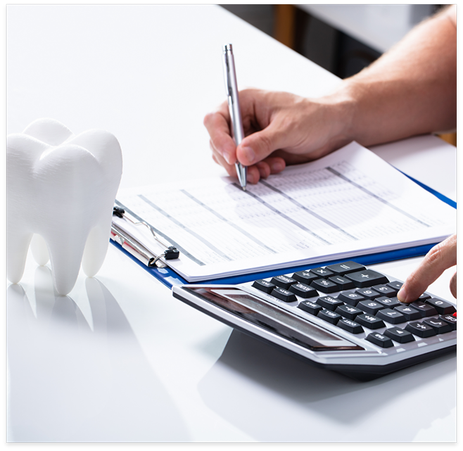 Tooth on table next to clipboard and calculator