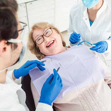 Patient smiling at dentist during exam