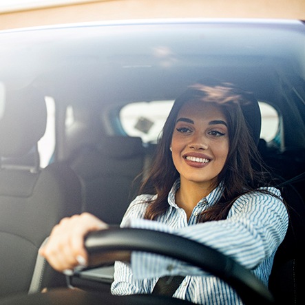 Woman smiling while driving