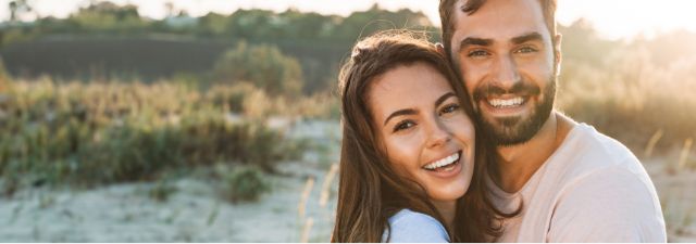 Man and woman smiling together outside