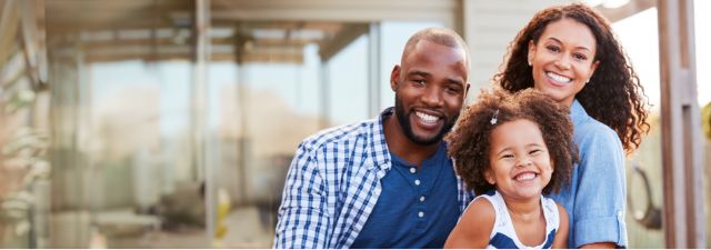 Entire family smiling in living room