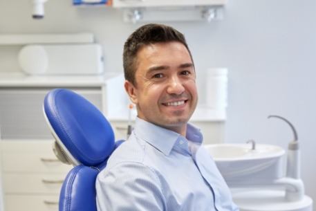 Man smiling during dental checkup for early prevention