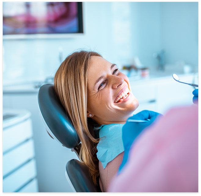 Woman sitting in dental chair and laughing