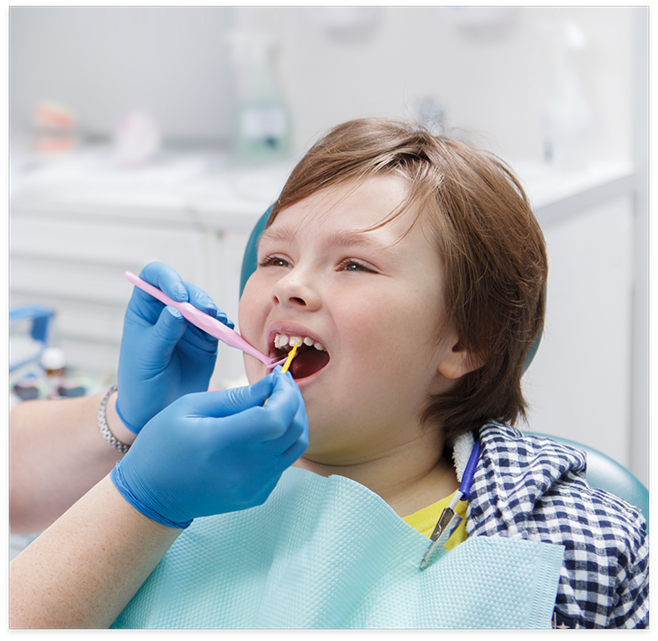 Little boy receiving a fluoride treatment