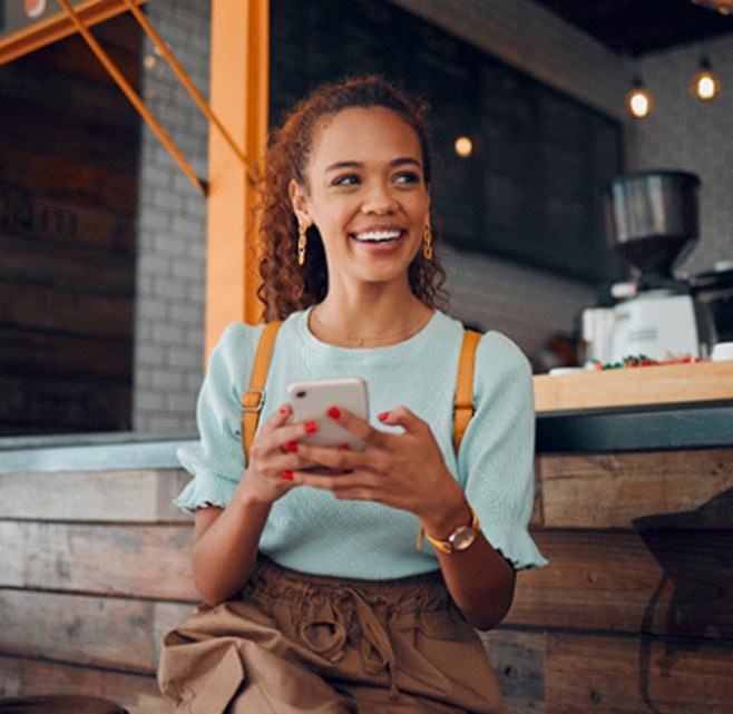 Smiling woman sitting on barstool at restaurant