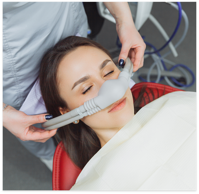 Woman having mask placed over nose for dental sedation