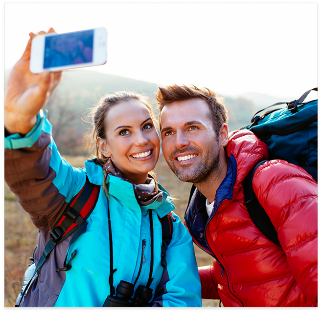 Man and woman taking selfie while hiking