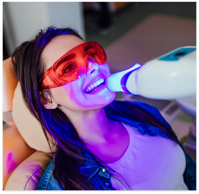 Woman sitting in dental chair receiving teeth whitening in Cottonwood Heights