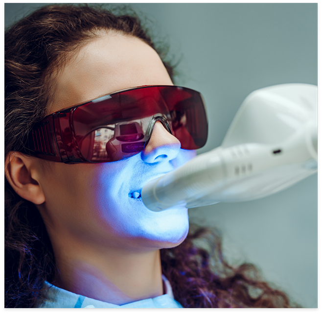 Woman receiving teeth whitening treatment